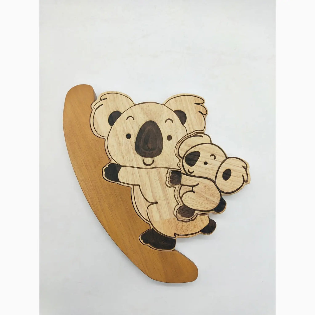 Wooden koala and baby on branch.