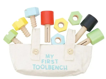 Colorful wooden toy tool set in a canvas bag.