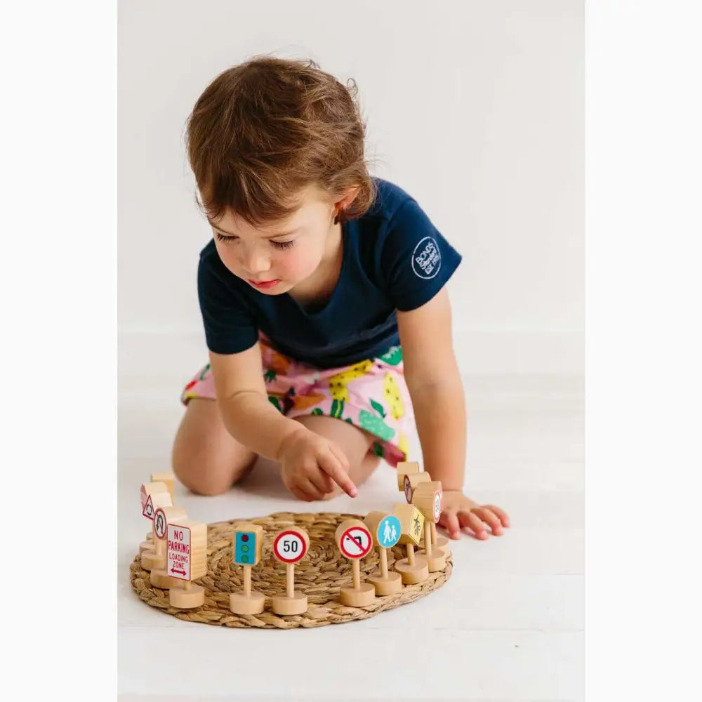 Wooden circular toy with colorful pegs and traffic signs.