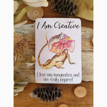 Affirmation card featuring a colorful illustration of a fantastical lizard-like creature with an umbrella-shaped head.