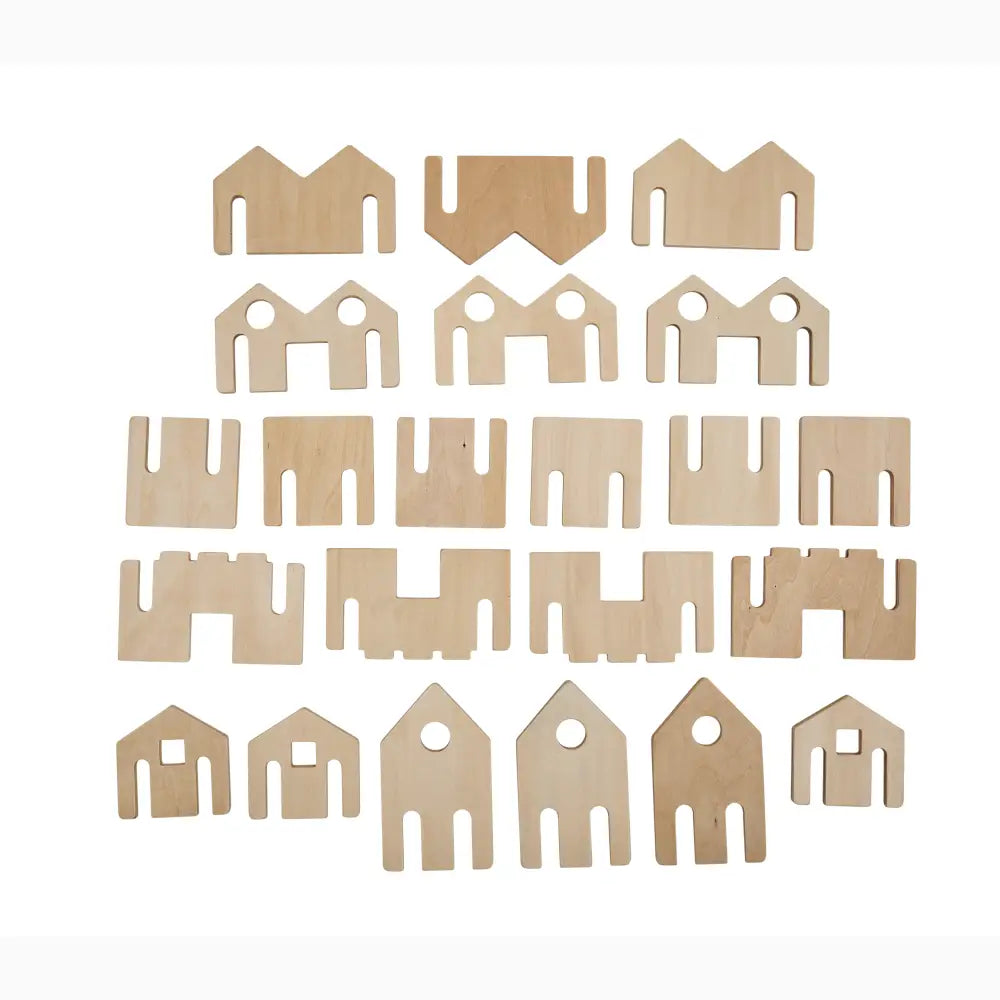 Collection of wooden or cardboard cutouts in various geometric shapes resembling simplified house or building forms.