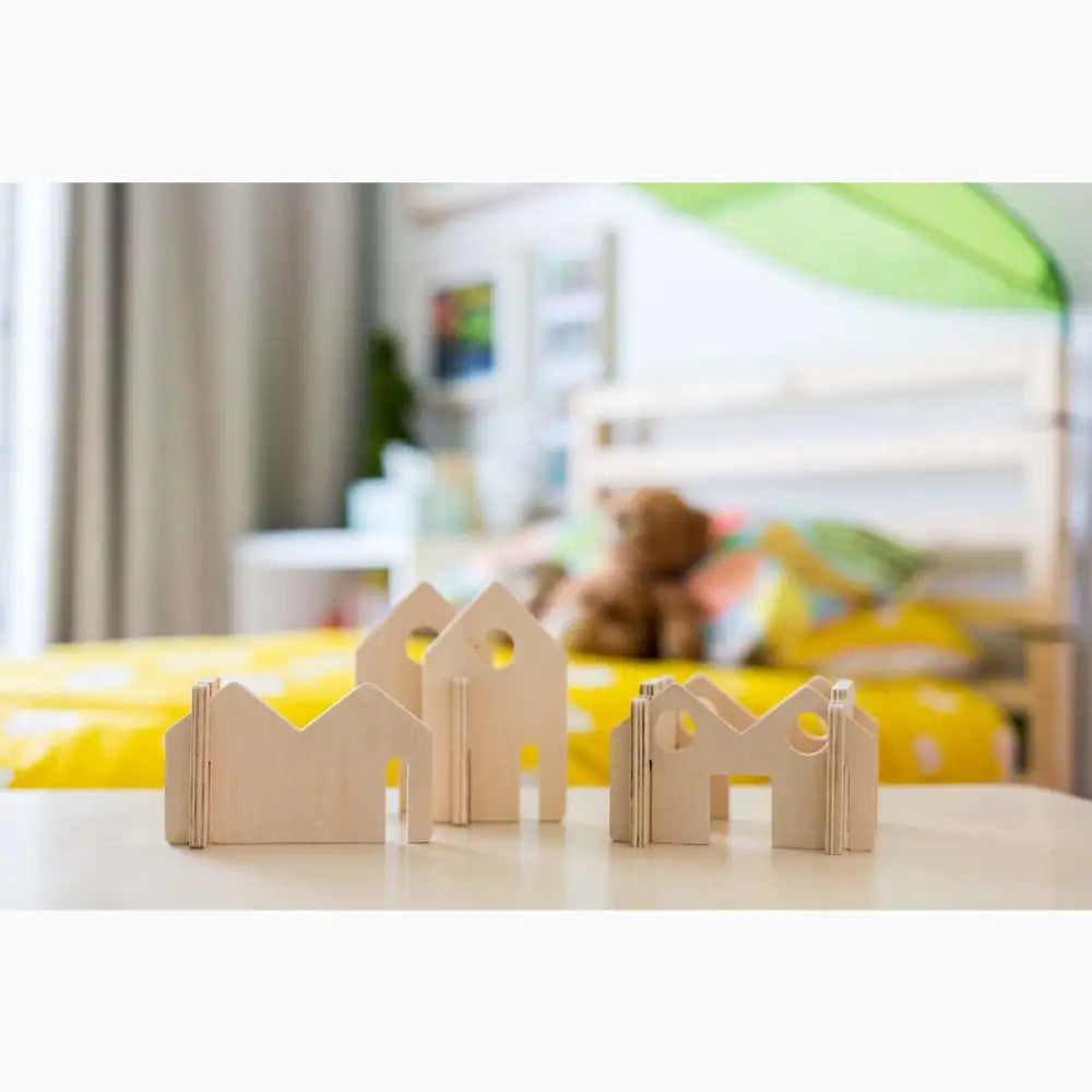 Wooden building blocks shaped like simple houses or structures.