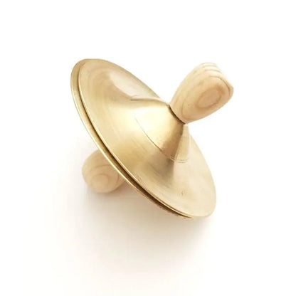 Golden spinning top with a smooth, rounded shape.