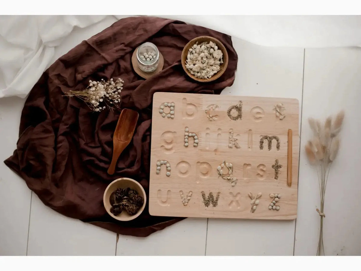 Wooden alphabet tracing board with lowercase letters and hand symbols.