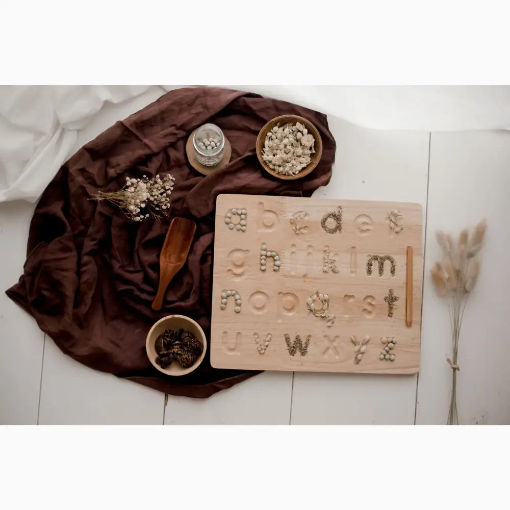 Wooden alphabet tracing board with lowercase letters and hand symbols.