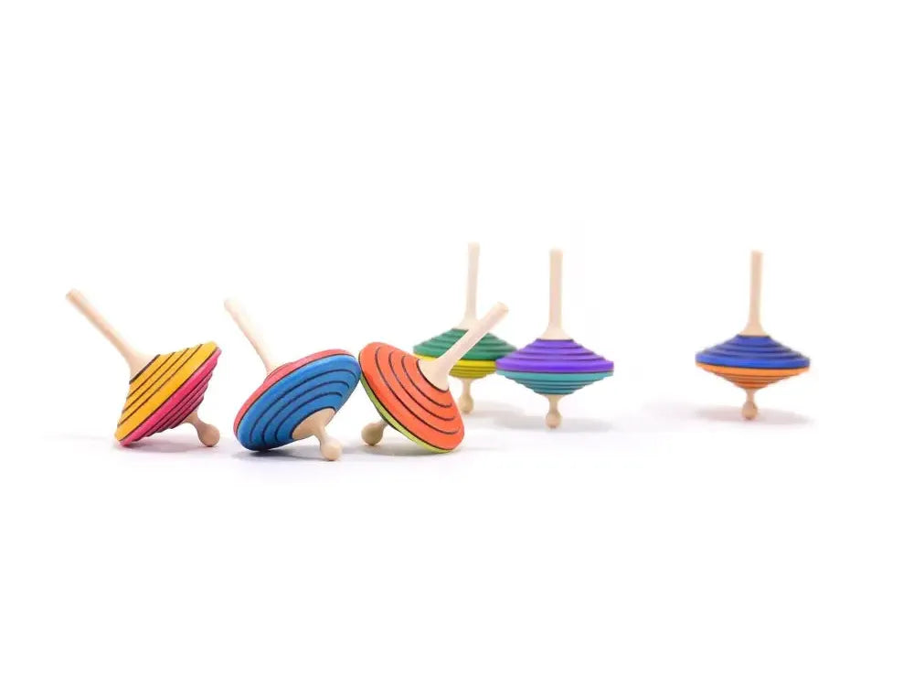 Colorful wooden spinning tops arranged in a row.