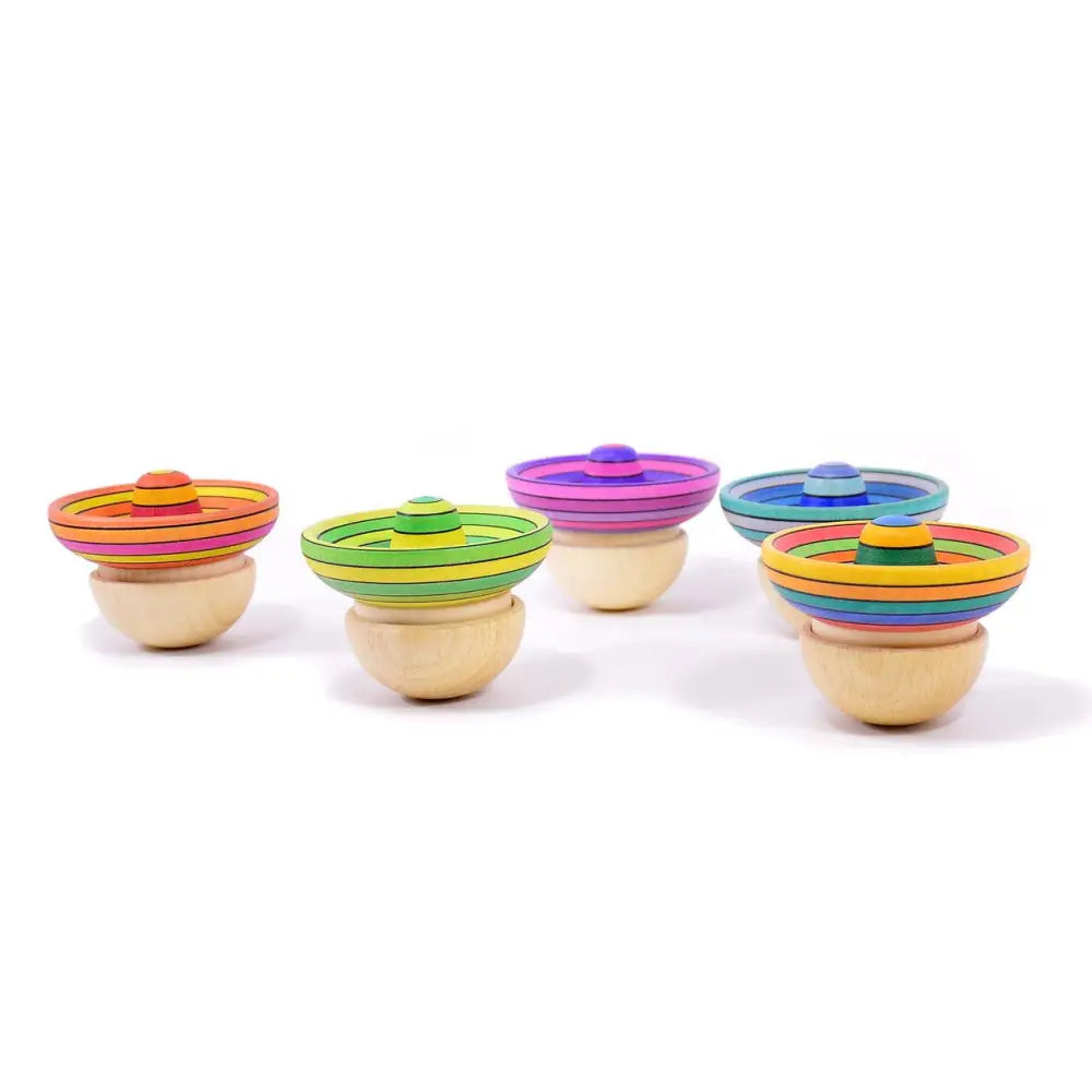 Colorful spinning tops with striped domed tops and wooden bases.
