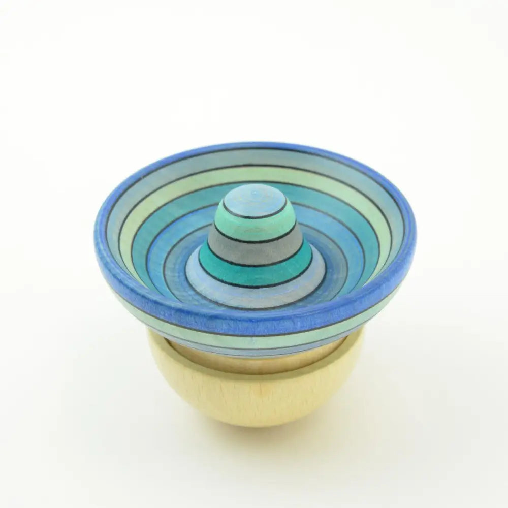 Colorful nested ceramic bowls with concentric circular patterns in blue and green tones.