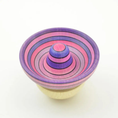 Colorful striped spinning top with concentric circles in pink and purple.