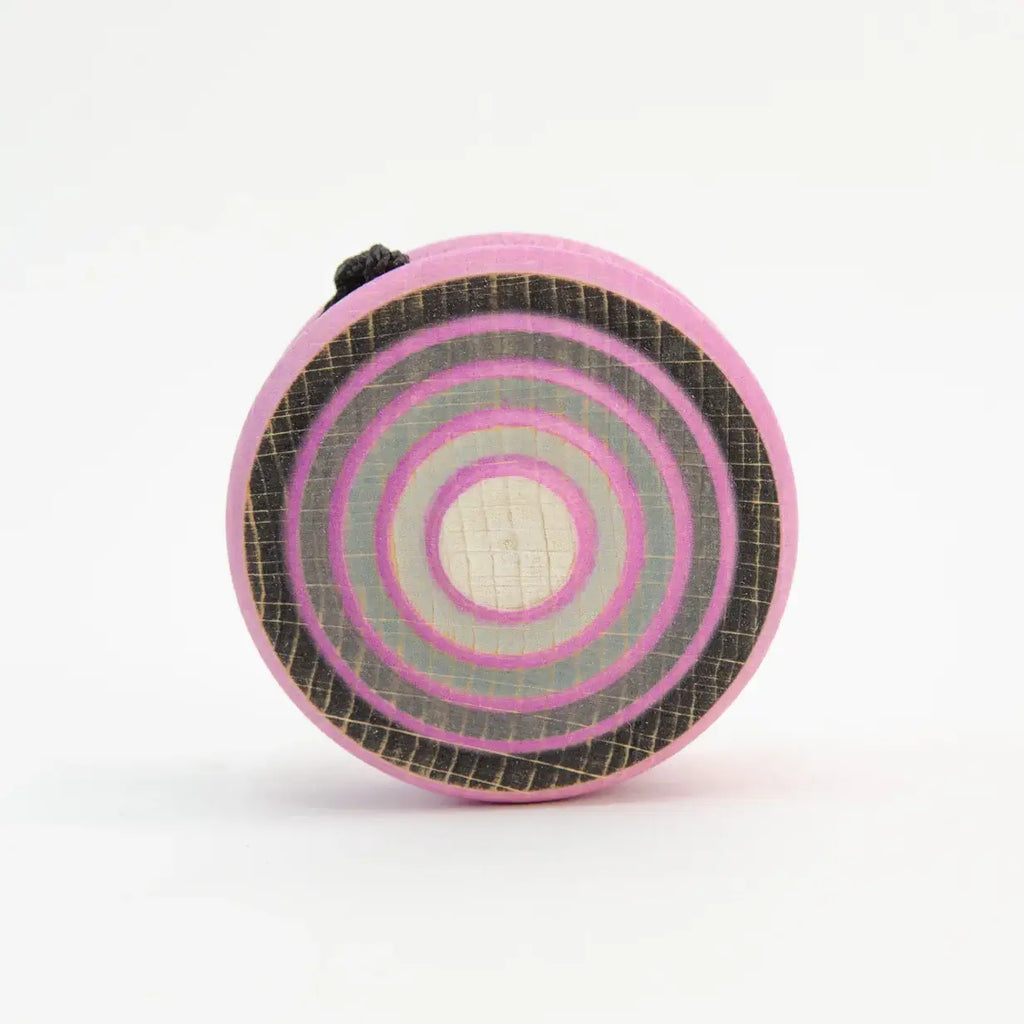 Pink and gray target-patterned wooden toy.