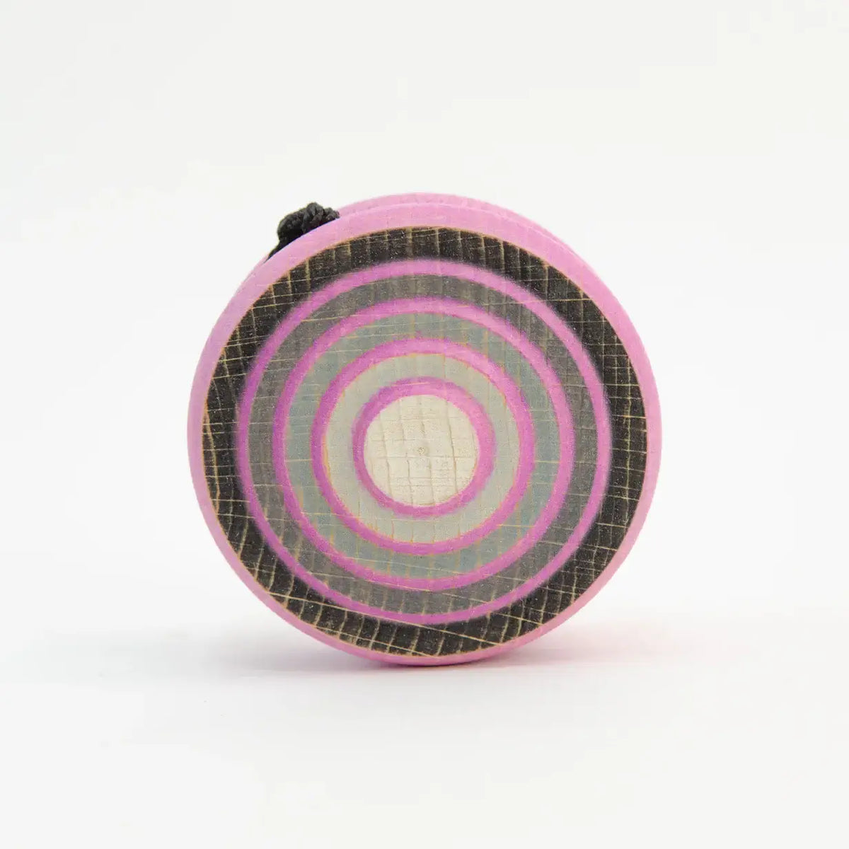 Pink and gray target-patterned wooden toy.