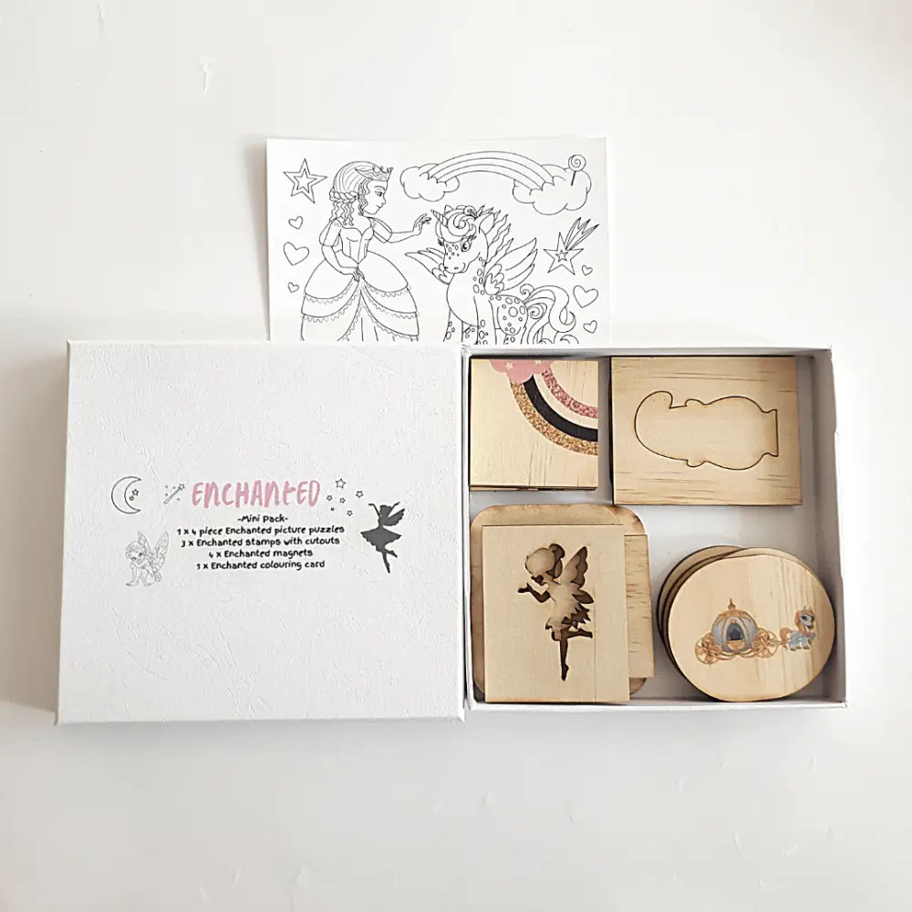 Wooden stamp set with fairy tale-themed designs in a box labeled ’Enchanted’.