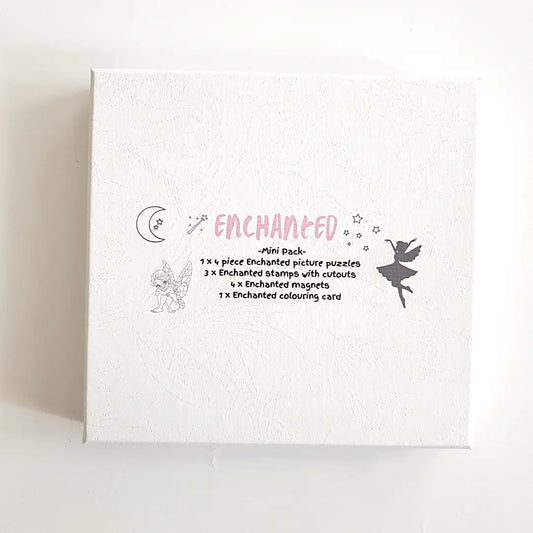 White box or package labeled ’Enchanted’ with decorative illustrations and text describing its contents.