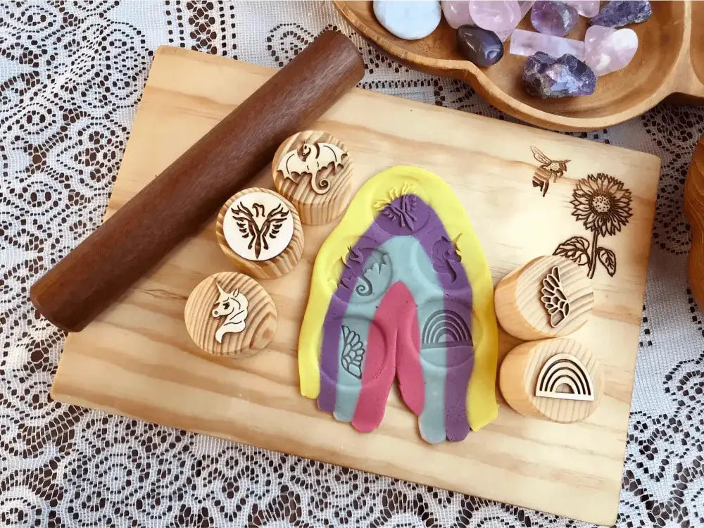 Colorful, arch-shaped playdough or clay creation with imprinted patterns.