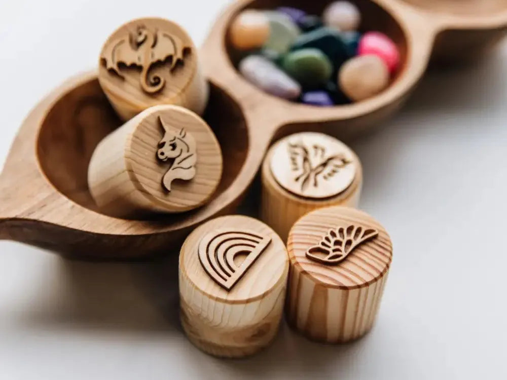 Wooden stamps with various engraved designs on their circular faces.