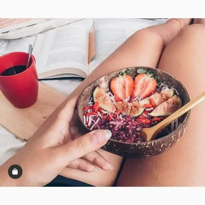 Coconut bowl with fruit and grains.