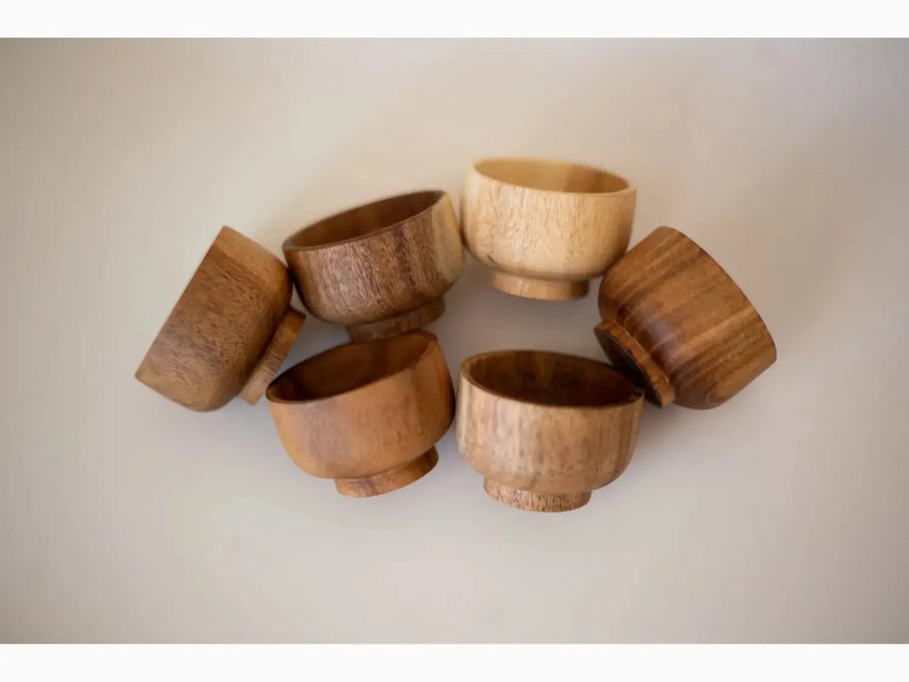 Collection of wooden bowls or cups arranged in a circular pattern.