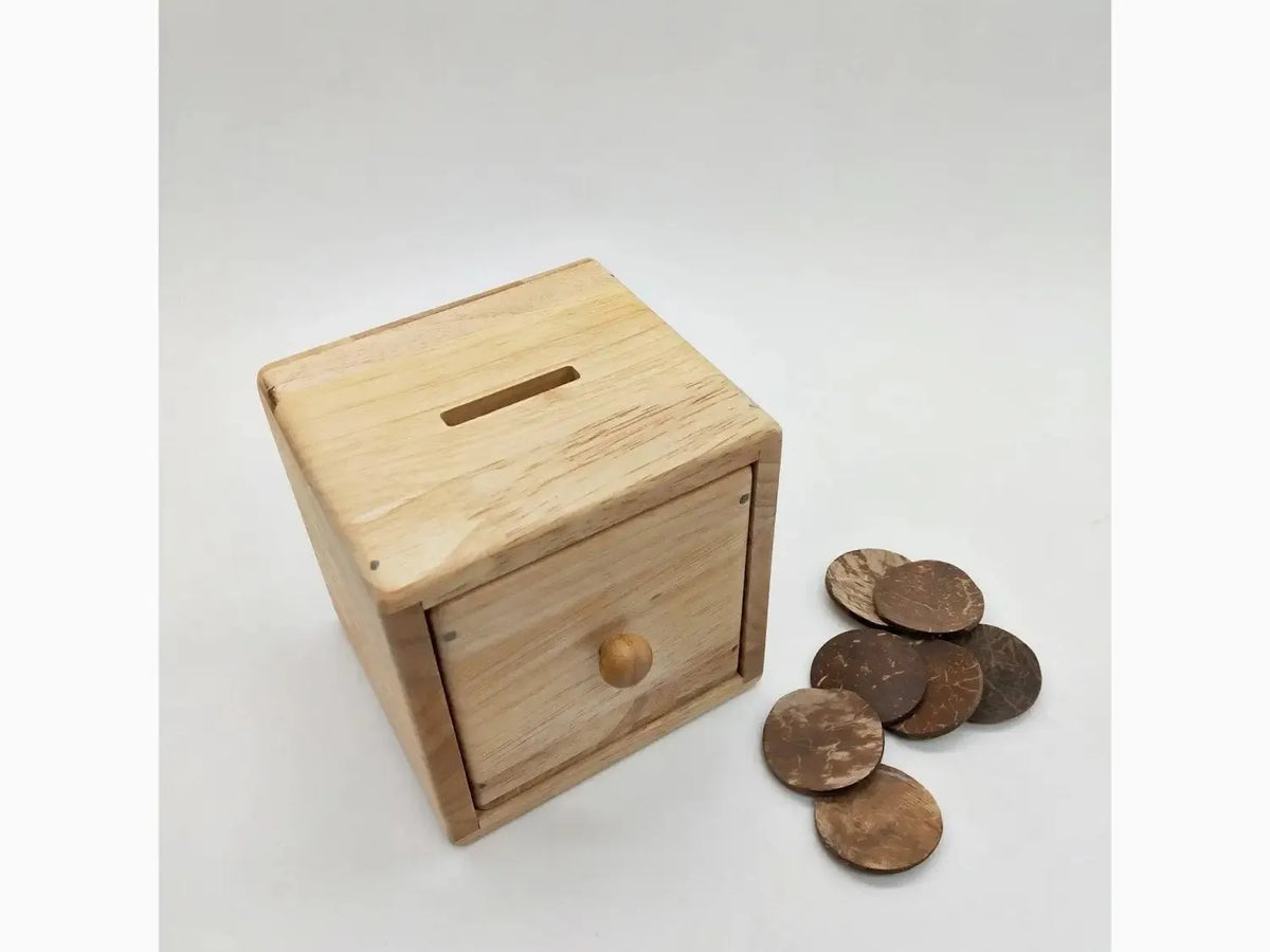 Wooden cube-shaped piggy bank with a small drawer.