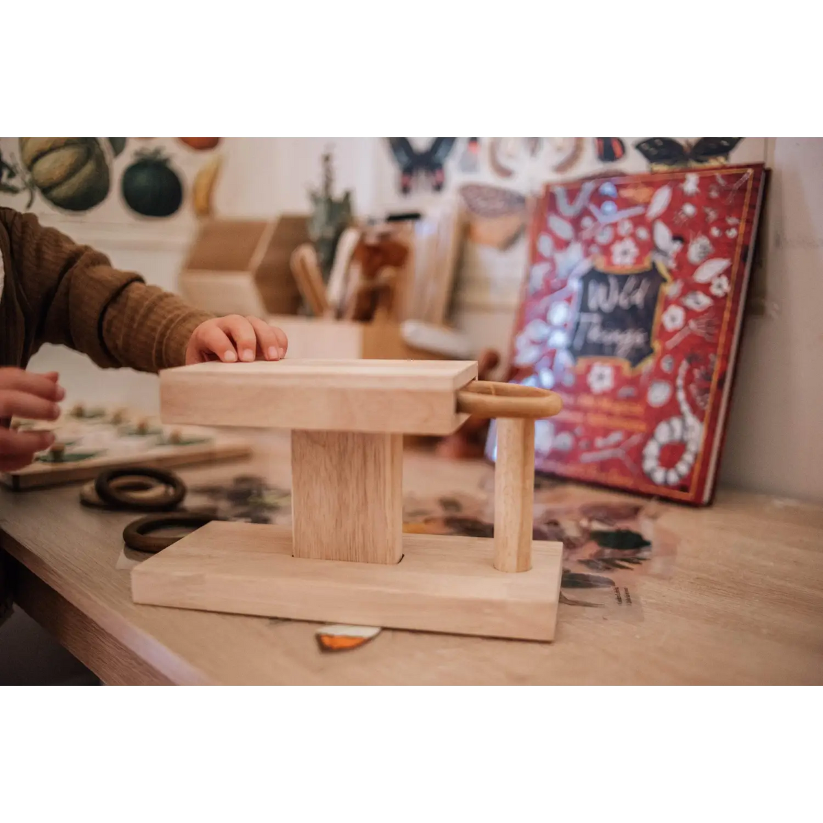 Wooden balance board or wobble board with a rectangular base and cylindrical fulcrum.