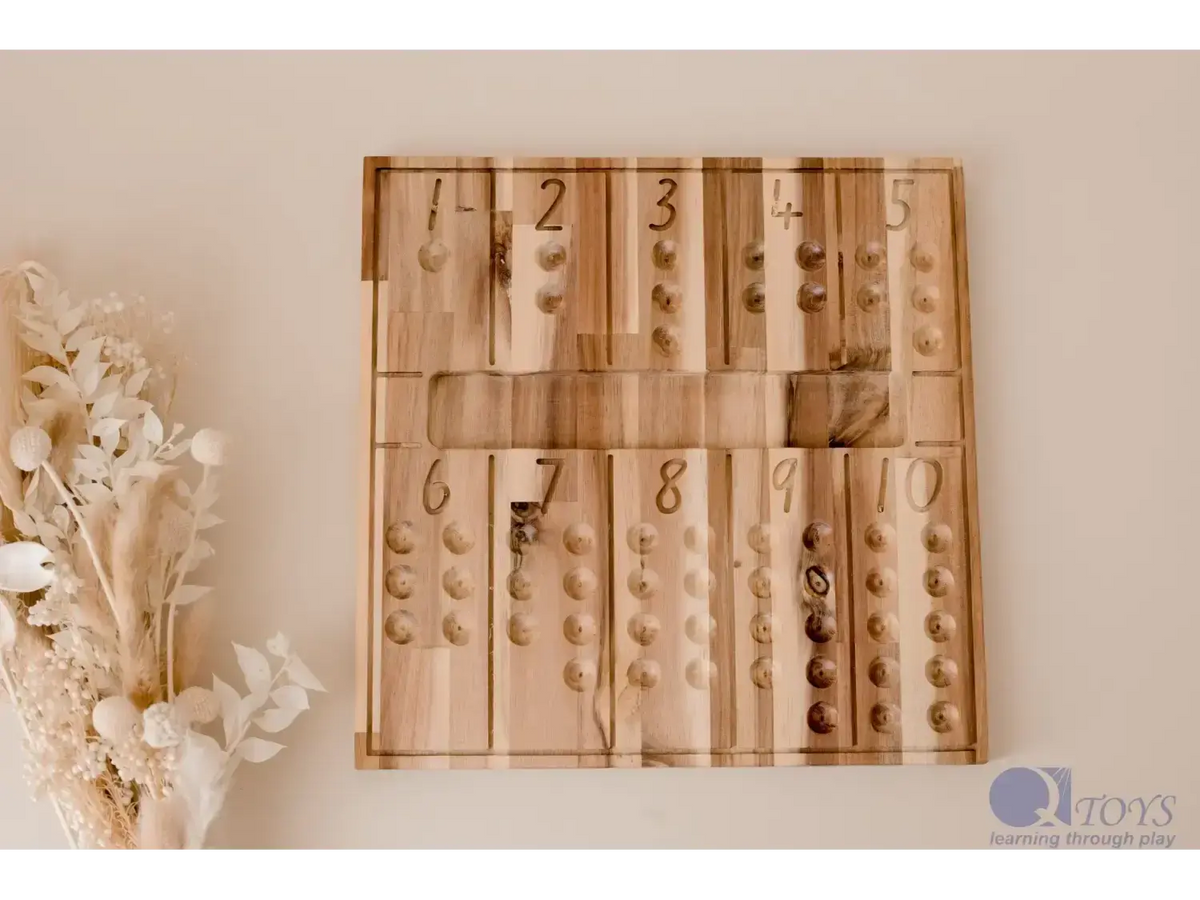Wooden number board with compartments displaying various quantities of small objects.