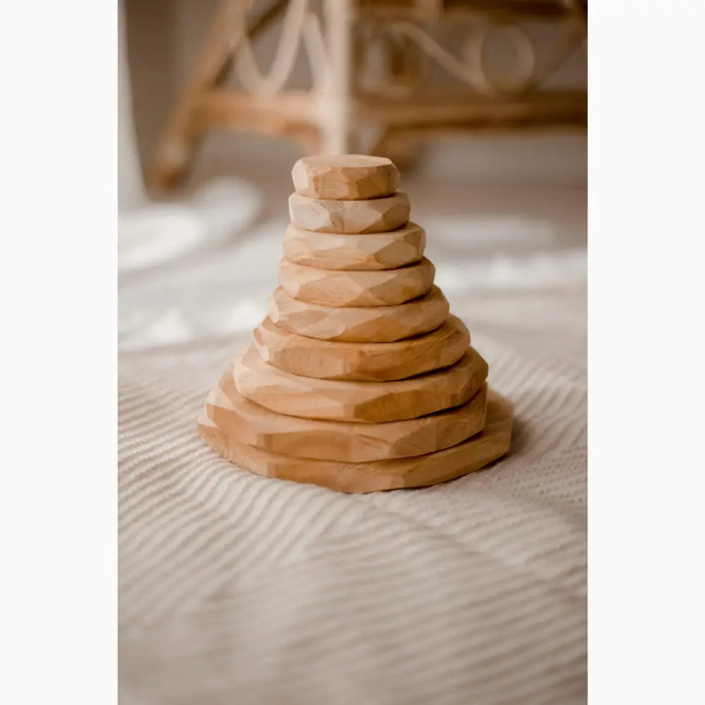 Wooden stacking toy with circular discs arranged in a pyramid shape.