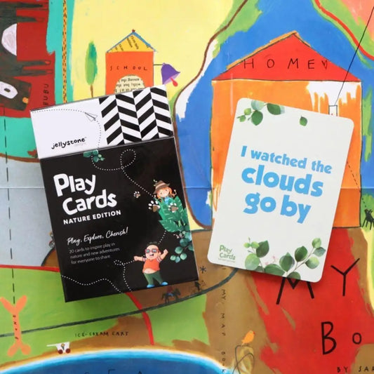 Two children’s books or card sets titled ’Play Cards Nature Edition’ and ’I watched the clouds go by’ on a colorful illustrated background.