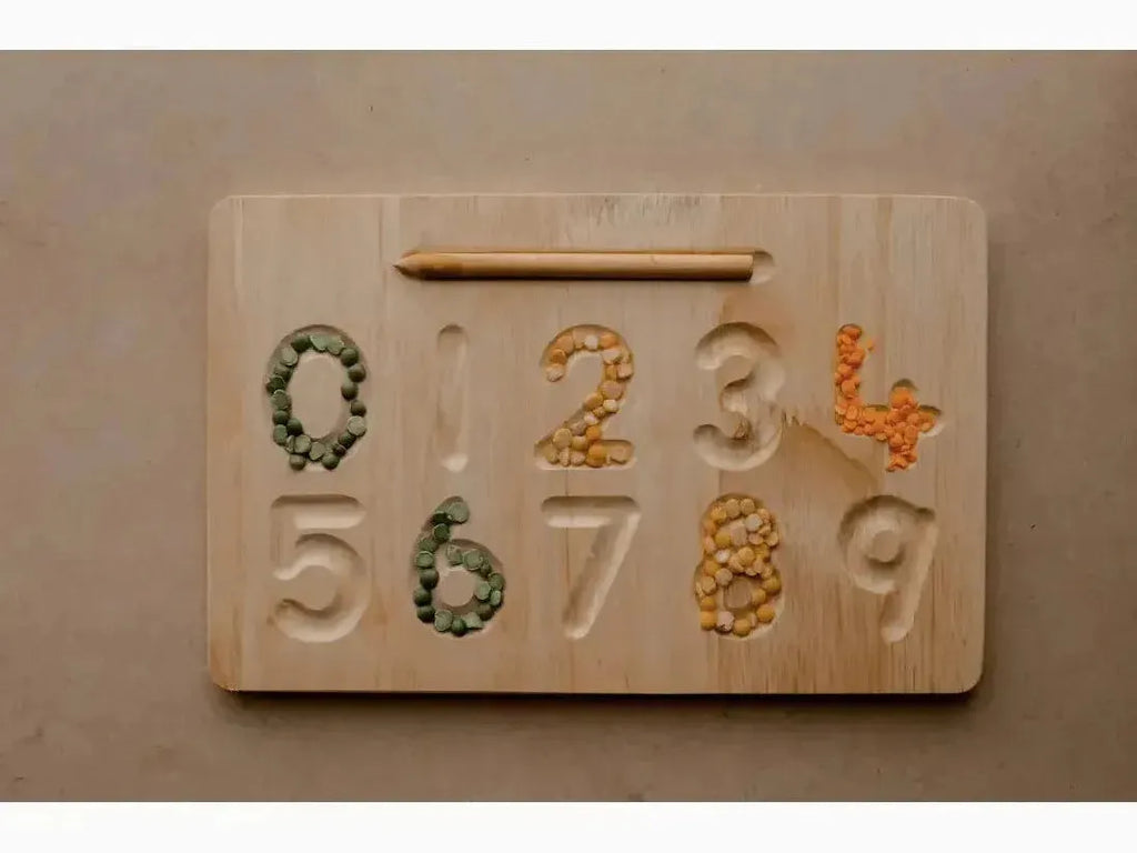 Wooden number board with carved digits filled with colorful beans or seeds.