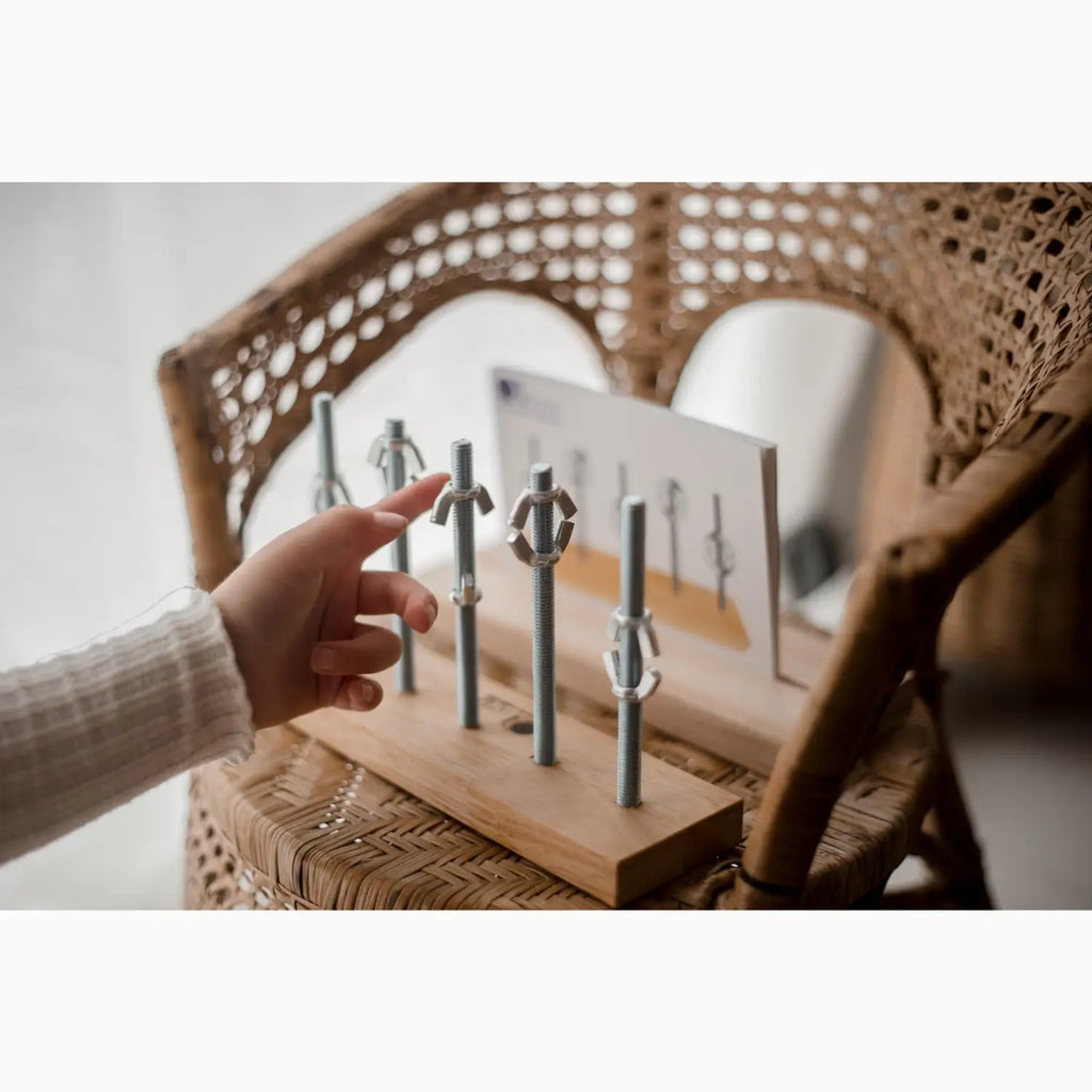 Wooden stand with metal figures.