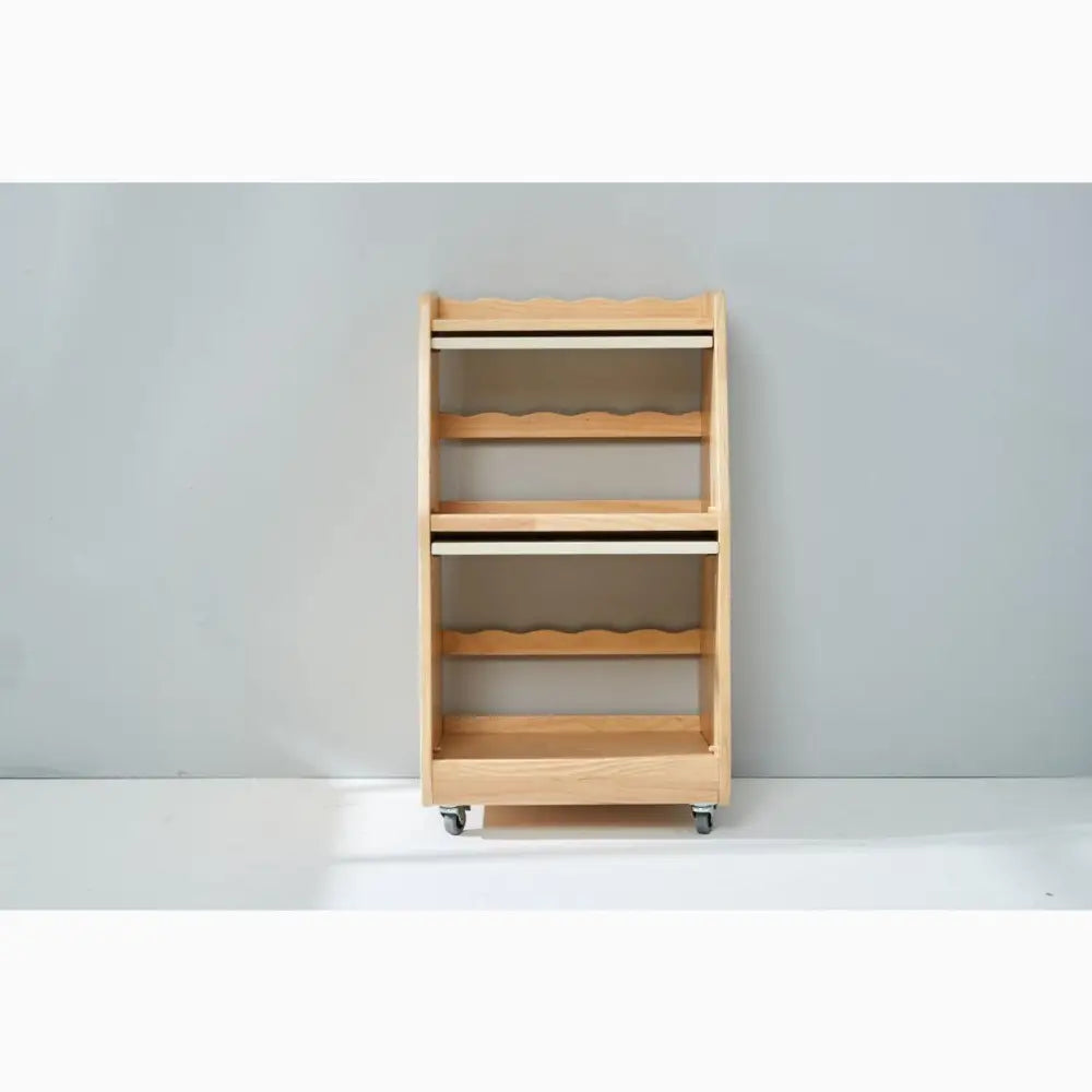 Wooden rolling cart with open shelves and scalloped edges.