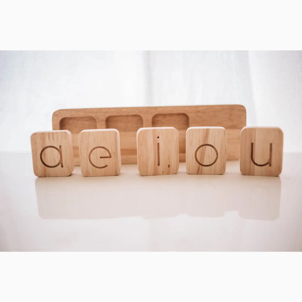 Wooden vowel blocks.