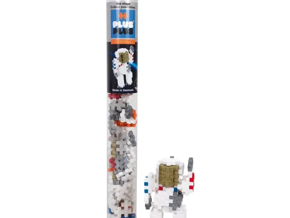 Clear plastic tube containing a space-themed building block set with an astronaut figure visible.