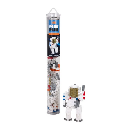 Clear plastic tube containing a space-themed building block set with an astronaut figure visible.