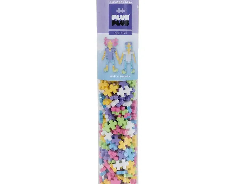 Cylindrical tube filled with colorful Plus Plus building blocks.