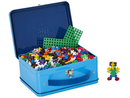 Blue metal lunchbox-style case filled with colorful plastic building blocks and pieces.