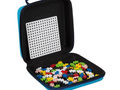 Carrying case containing colorful plastic building blocks and a perforated board.