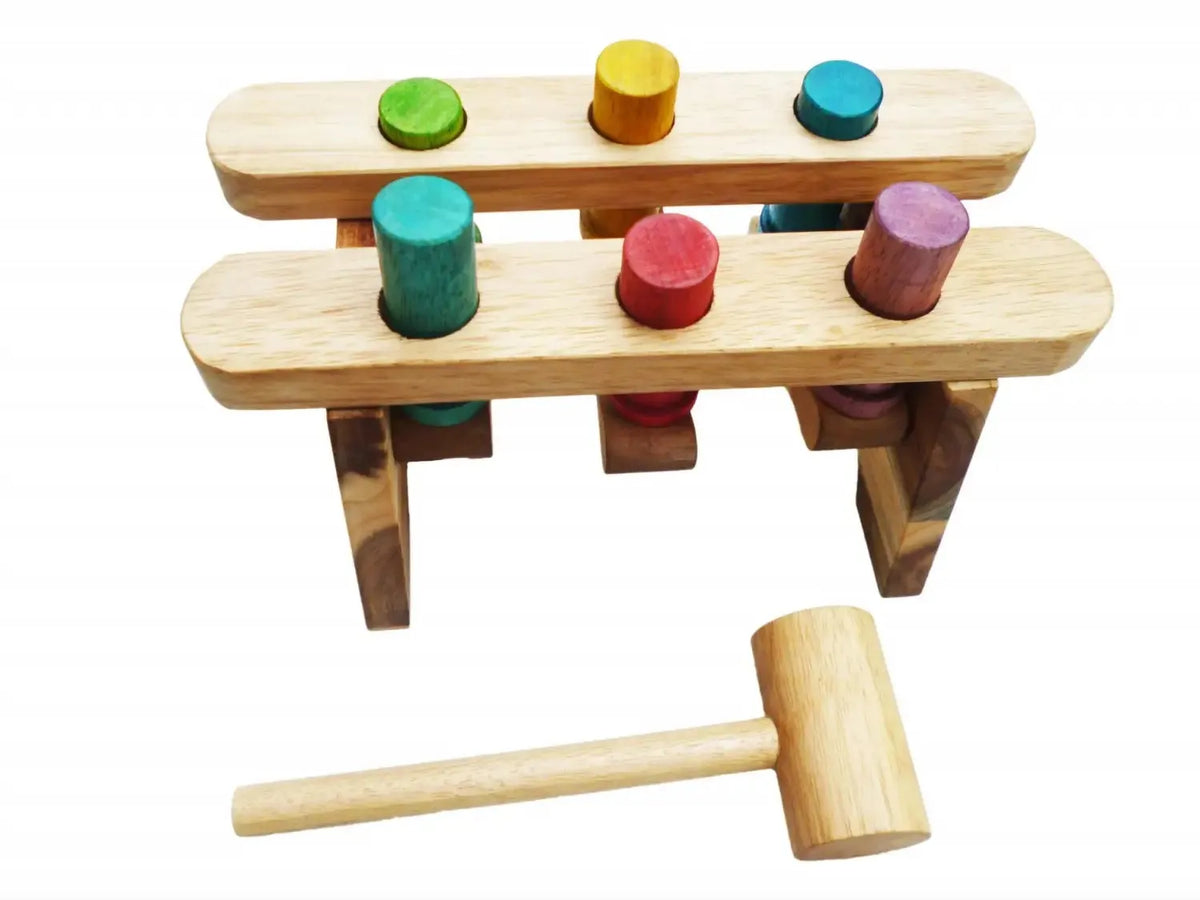 Wooden toy hammer game with colorful pegs on a two-tiered platform.