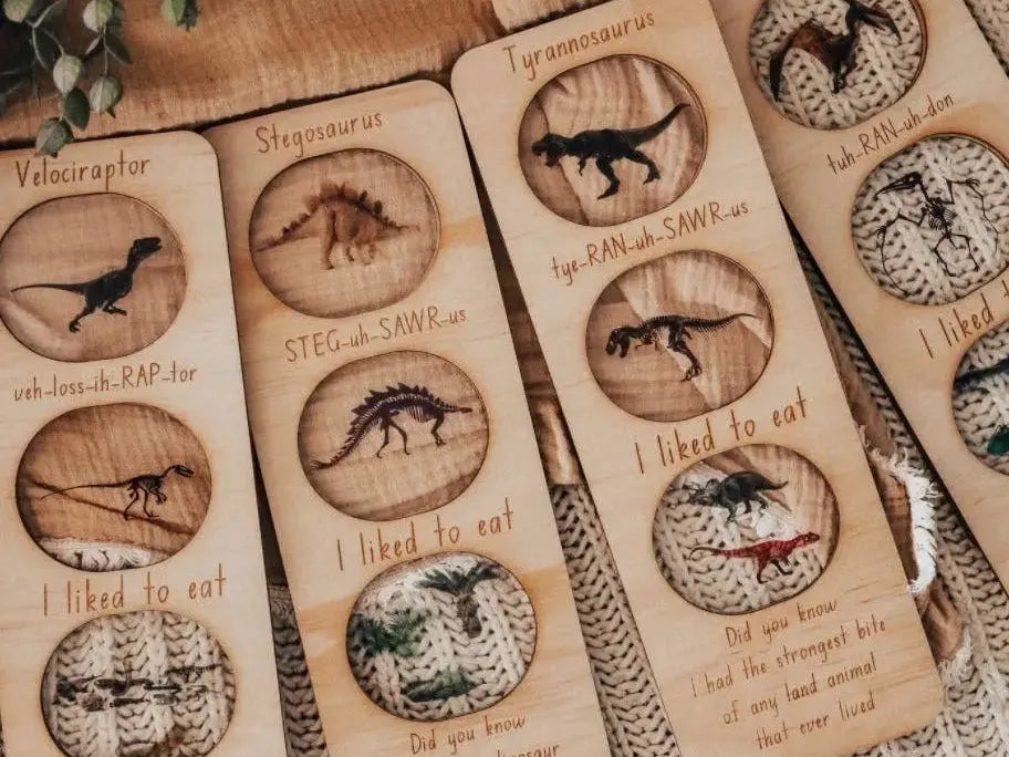 Wooden bookmarks featuring engraved dinosaur illustrations and facts.