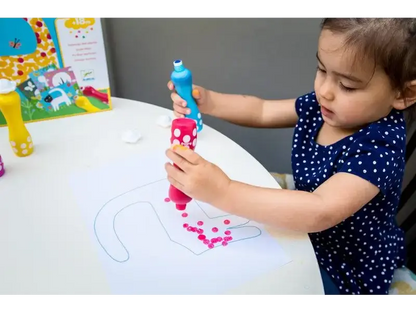 Child playing with a colorful drawing toy on a white table.