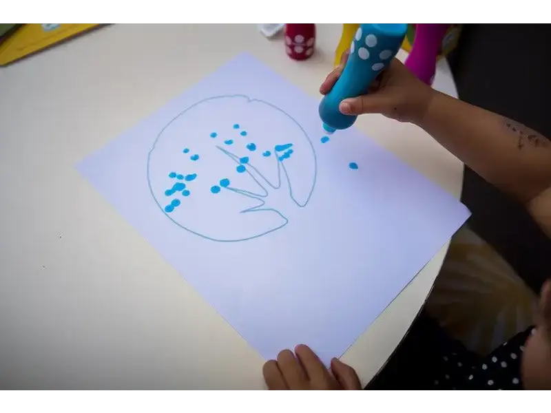 Drawing of a tree with blue dots representing leaves or blossoms.