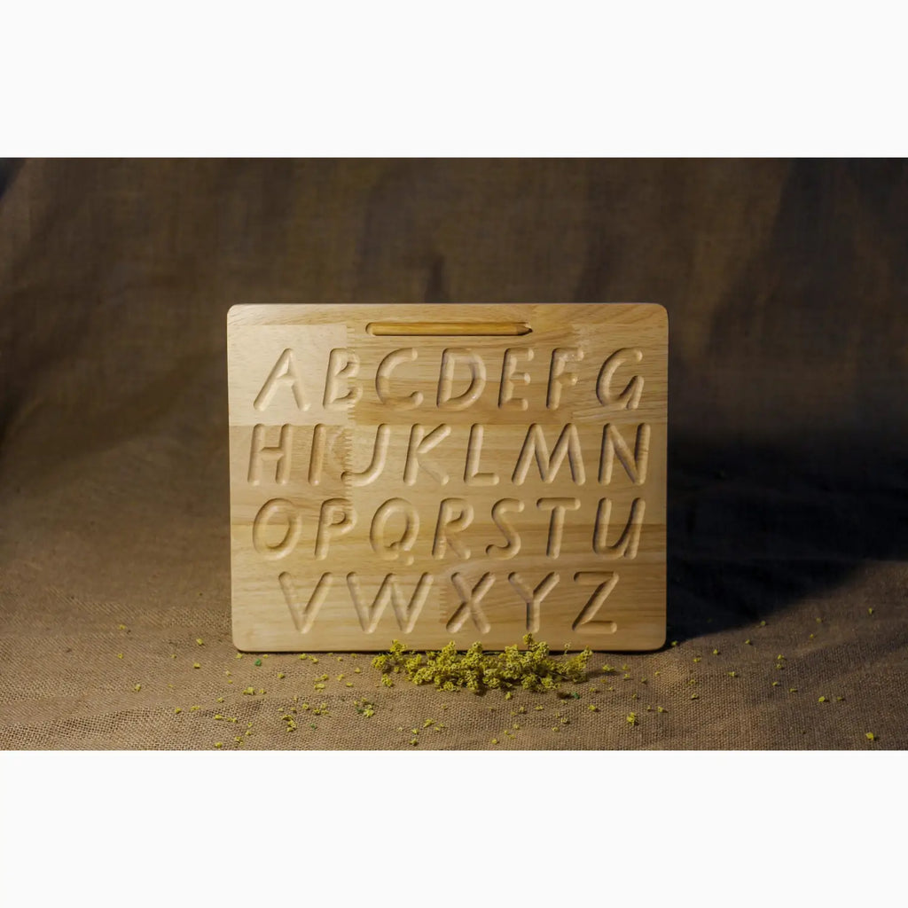 Wooden alphabet tracing board with carved uppercase letters.