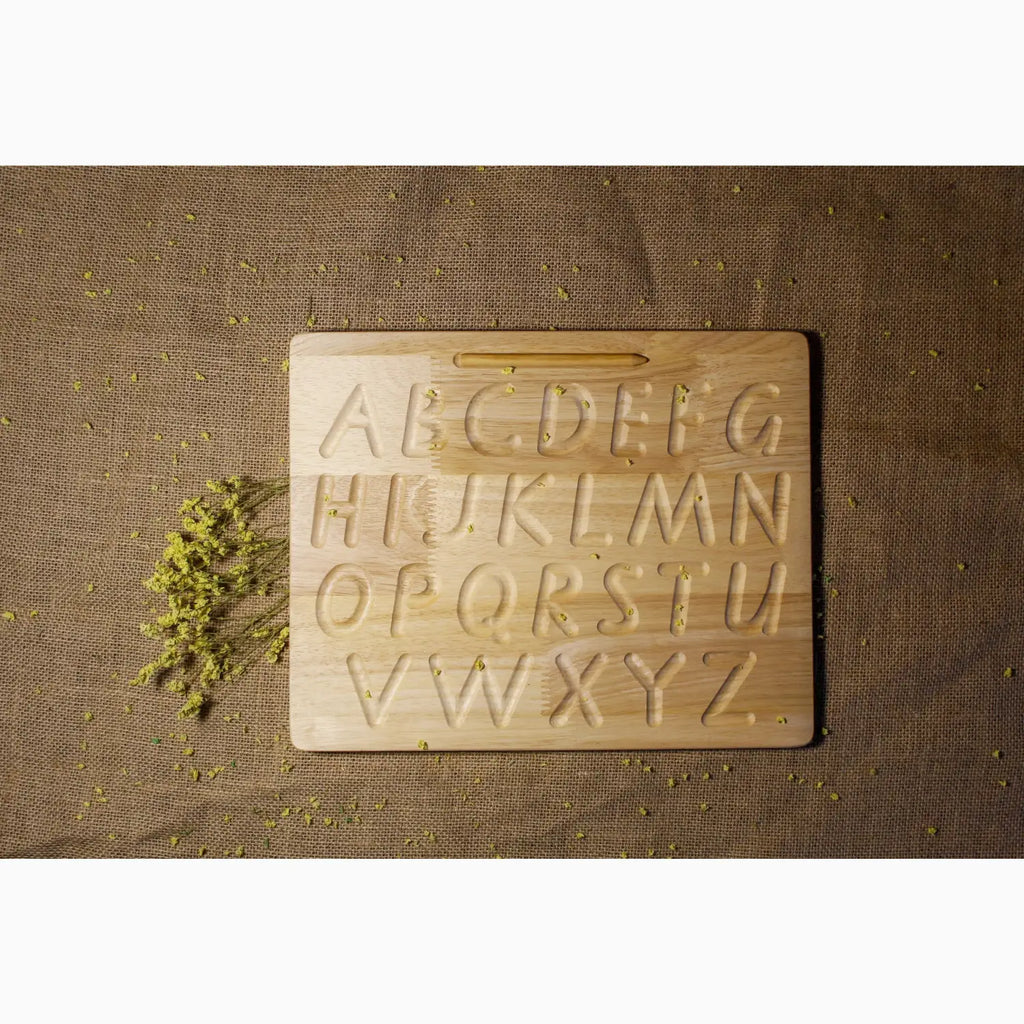 Wooden alphabet tracing board with uppercase letters engraved.