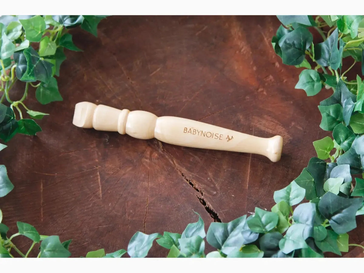 Wooden massage tool with rounded knobs on one end and a handle on the other.