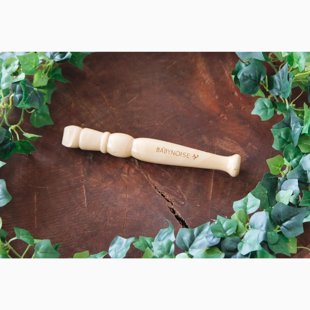 Wooden massage tool with rounded knobs on one end and a handle on the other.