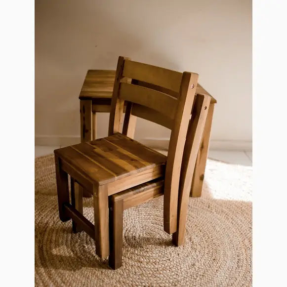 Stacked wooden chairs.