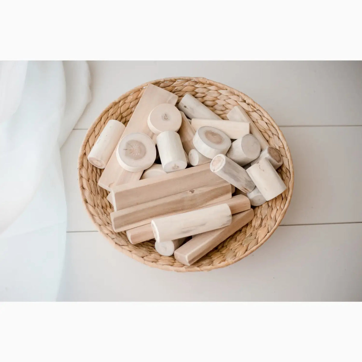 Wicker basket filled with wooden blocks.