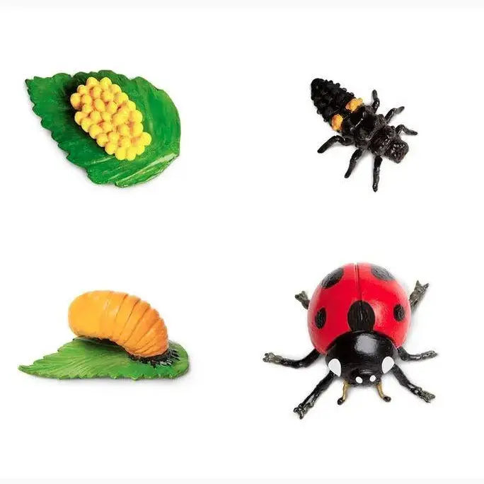 Collection of toy insects and corn on small plastic leaves.