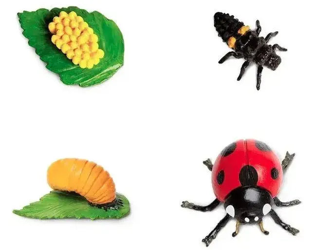 Collection of toy insects and corn on small plastic leaves.