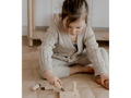 Child playing with wooden toy tools.