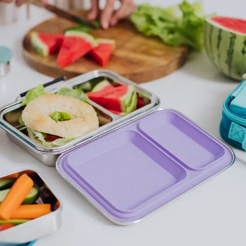 Stainless steel lunchbox with a purple plastic lid.