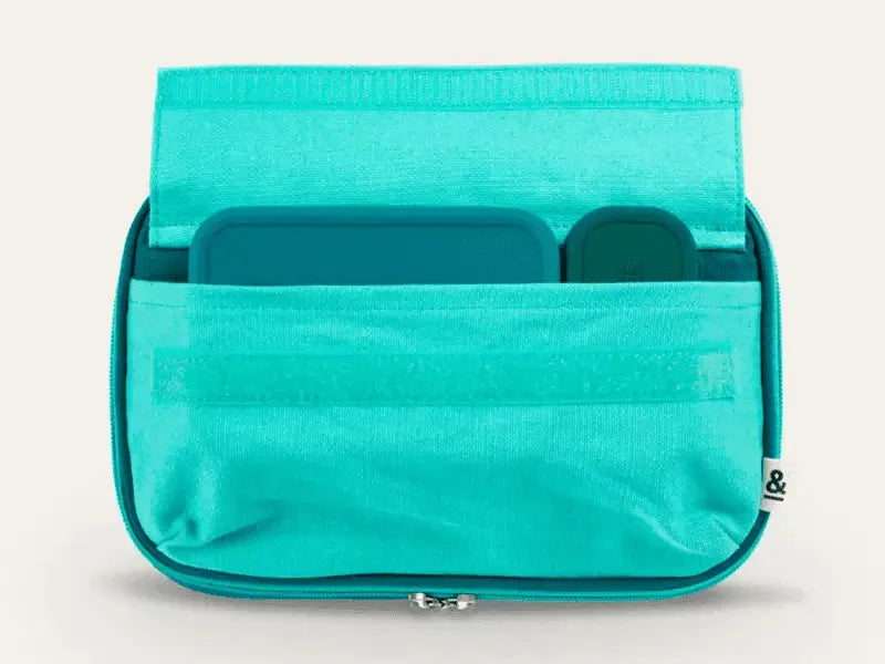Turquoise fabric organizer with multiple pockets and a zipper closure.